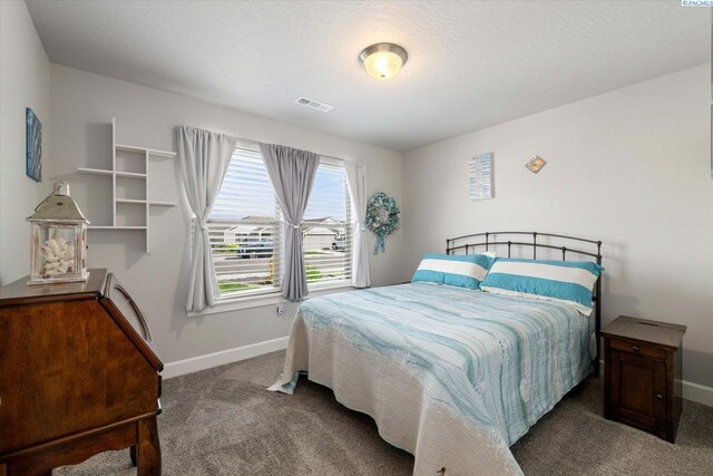 carpeted bedroom featuring baseboards and visible vents