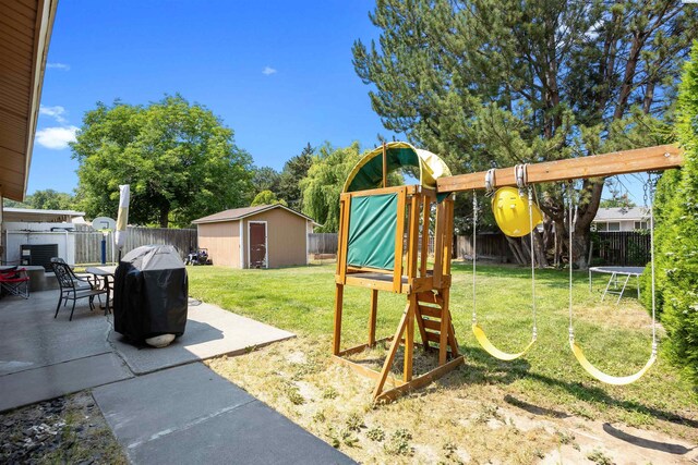 506 W 19th Ave, Kennewick, WA 99337 - fenced backyard featuring a shed, a patio, a playground, and a trampoline