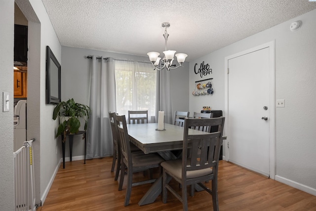 506 W 19th Ave, Kennewick, WA 99337 - dining space featuring a chandelier, light wood-style floors, and a textured ceiling