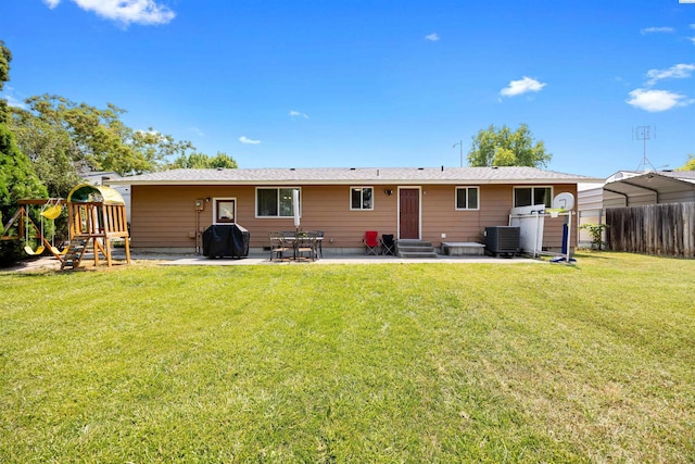 506 W 19th Ave, Kennewick, WA 99337 - back of house with entry steps, a patio area, a detached carport, and a playground