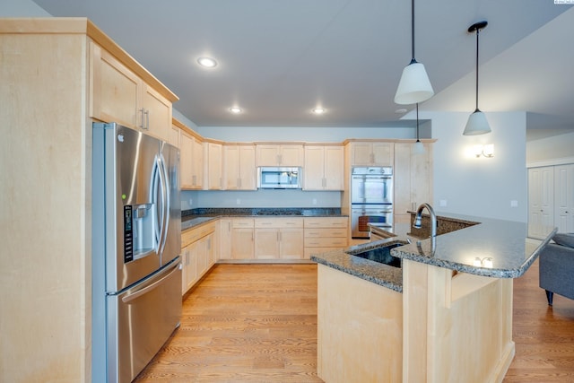 kitchen featuring pendant lighting, sink, stainless steel appliances, light hardwood / wood-style floors, and light brown cabinetry