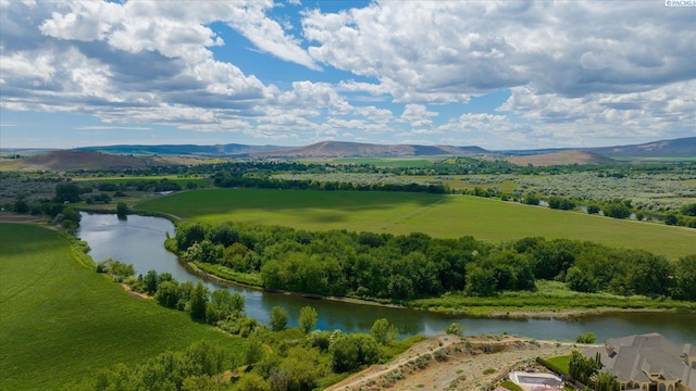 drone / aerial view featuring a water and mountain view