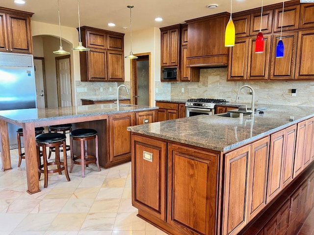 3041 Bluffs Dr, Richland, WA 99354 - kitchen with pendant lighting, sink, custom exhaust hood, built in appliances, and kitchen peninsula