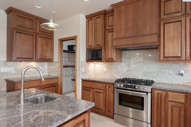 3041 Bluffs Dr, Richland, WA 99354 - kitchen featuring stainless steel gas range, sink, black microwave, and dark stone countertops