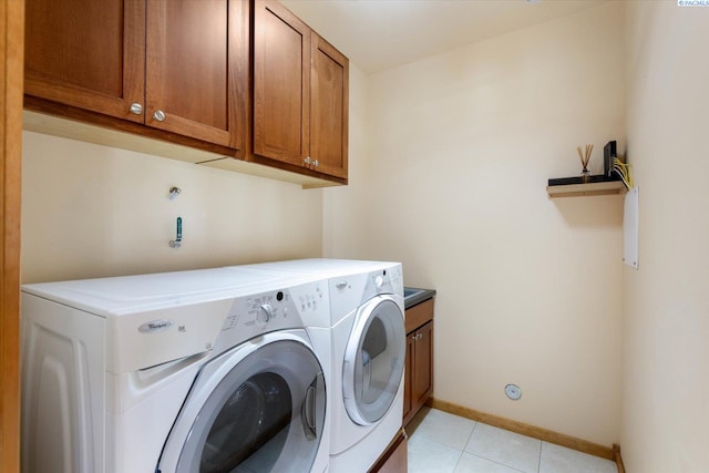3041 Bluffs Dr, Richland, WA 99354 - laundry area with cabinets, washer and dryer, and light tile patterned floors