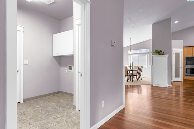 laundry room featuring cabinets and light hardwood / wood-style floors