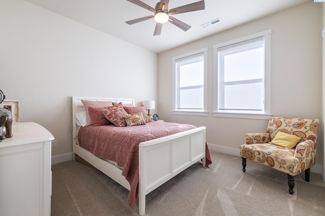 bedroom with carpet floors, baseboards, visible vents, and ceiling fan