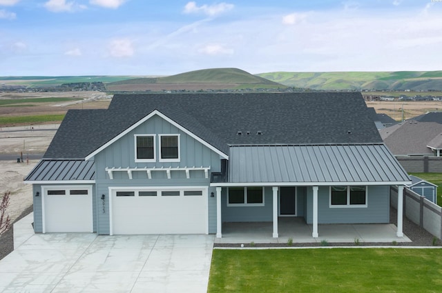 view of front of property with a porch, a mountain view, and a front lawn