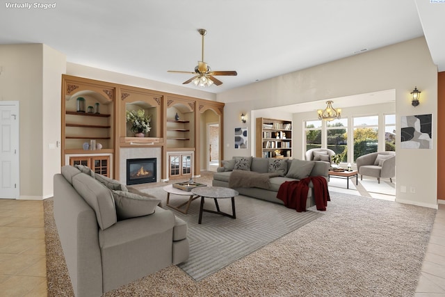 living room with light tile patterned floors, a fireplace, baseboards, and built in features