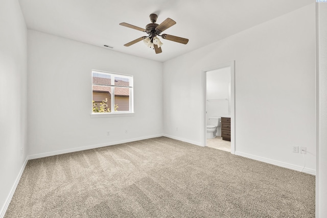 unfurnished room featuring light carpet, visible vents, a ceiling fan, and baseboards