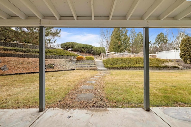 view of yard featuring a patio, stairway, and fence