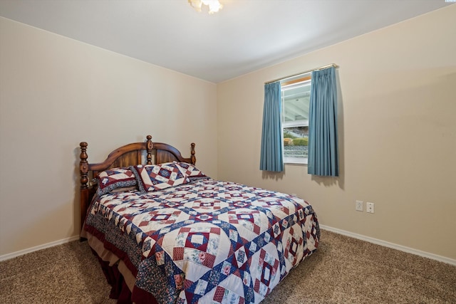 bedroom featuring carpet and baseboards