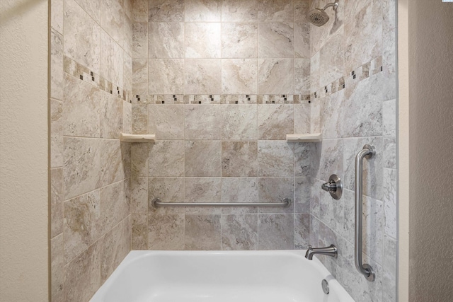 full bath with a textured wall and tub / shower combination