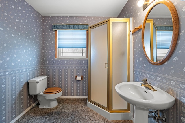 full bathroom featuring a stall shower, toilet, and wallpapered walls