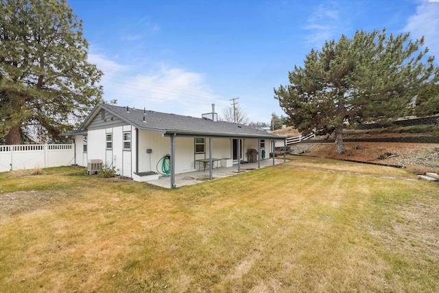 back of property featuring a patio area, a fenced backyard, a lawn, and central AC