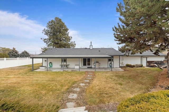 rear view of house featuring a yard, fence, and a patio