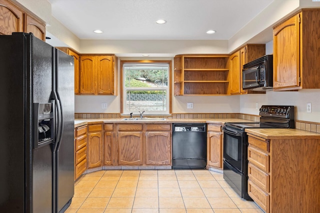 kitchen with light tile patterned floors, open shelves, light countertops, a sink, and black appliances