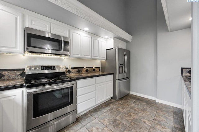 823 S 5th Ave, Pasco, WA 99301 - kitchen featuring stainless steel appliances, dark countertops, white cabinetry, and dark stone finish flooring