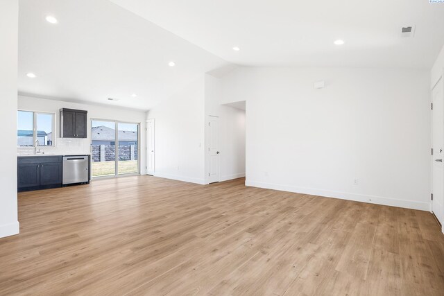 2925 S Osborne St, Kennewick, WA 99338 - unfurnished living room with vaulted ceiling, baseboards, a sink, light wood-type flooring, and recessed lighting