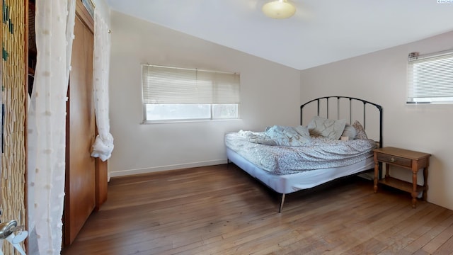 1810 NE Wheatland Dr, Pullman, WA 99163 - bedroom featuring baseboards, lofted ceiling, and wood-type flooring