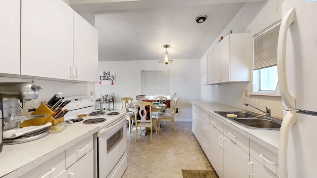 1810 NE Wheatland Dr, Pullman, WA 99163 - kitchen featuring white cabinets, white appliances, light countertops, and a sink