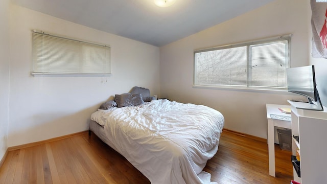 1810 NE Wheatland Dr, Pullman, WA 99163 - bedroom featuring lofted ceiling, hardwood / wood-style flooring, and baseboards