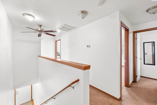 160604 Richards Rd, Prosser, WA 99350 - corridor with an upstairs landing, a textured ceiling, baseboards, light colored carpet, and visible vents