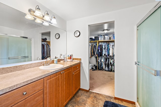 160604 Richards Rd, Prosser, WA 99350 - full bathroom with a spacious closet, vanity, baseboards, and a shower stall