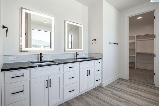 1839 S Union St, Kennewick, WA 99337 - bathroom featuring double vanity, wood finished floors, a spacious closet, and recessed lighting