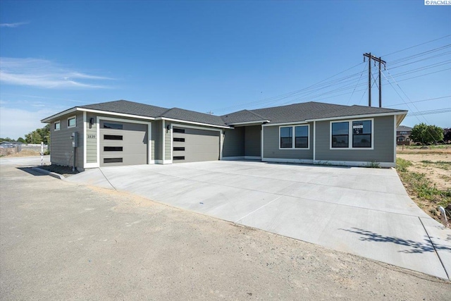1839 S Union St, Kennewick, WA 99337 - view of front facade featuring an attached garage and concrete driveway