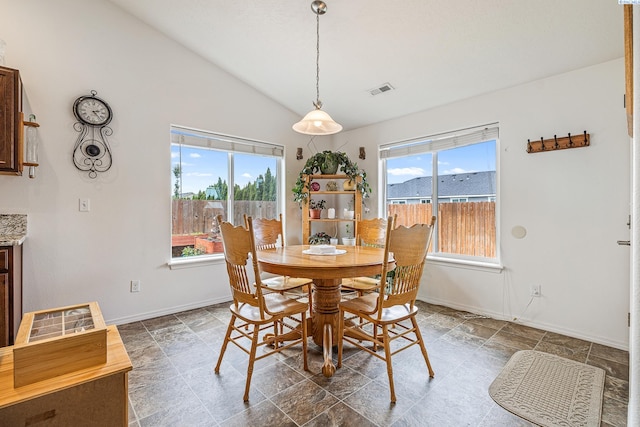 6110 Westport Ln, Pasco, WA 99301 - dining space featuring lofted ceiling, baseboards, and stone finish flooring
