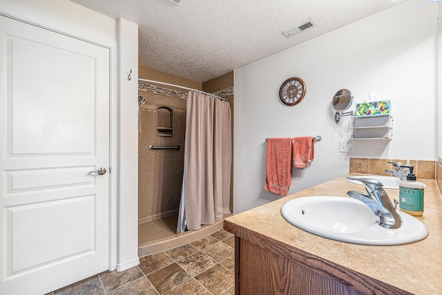 6110 Westport Ln, Pasco, WA 99301 - bathroom featuring a stall shower, a textured ceiling, and vanity