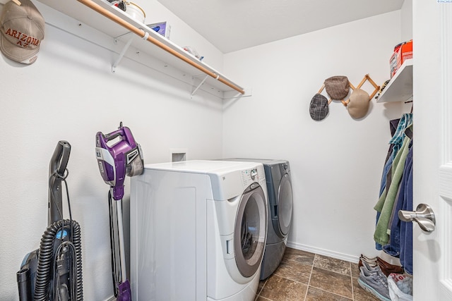 6110 Westport Ln, Pasco, WA 99301 - laundry room featuring washer and dryer, baseboards, and dark stone finish flooring