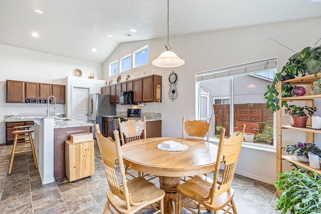 6110 Westport Ln, Pasco, WA 99301 - dining area with light stone finish floors, recessed lighting, baseboards, and high vaulted ceiling