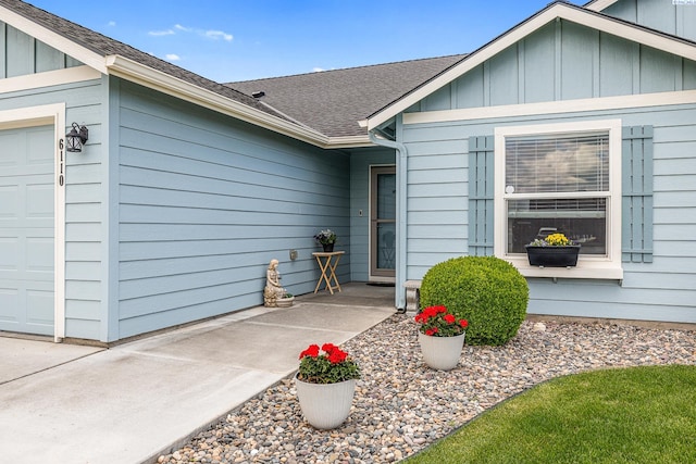 6110 Westport Ln, Pasco, WA 99301 - view of exterior entry with a garage, board and batten siding, and a shingled roof