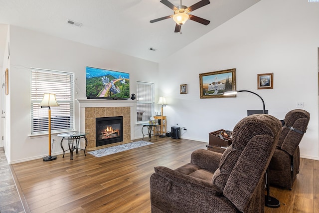 6110 Westport Ln, Pasco, WA 99301 - living room with a ceiling fan, wood finished floors, a tile fireplace, baseboards, and high vaulted ceiling
