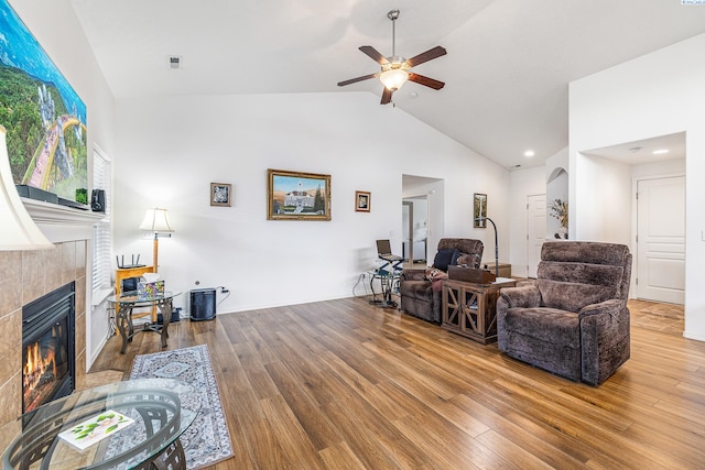 6110 Westport Ln, Pasco, WA 99301 - living area featuring a tiled fireplace, ceiling fan, wood finished floors, high vaulted ceiling, and recessed lighting