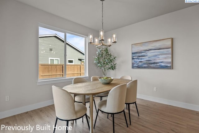 dining room featuring light hardwood / wood-style flooring and a chandelier