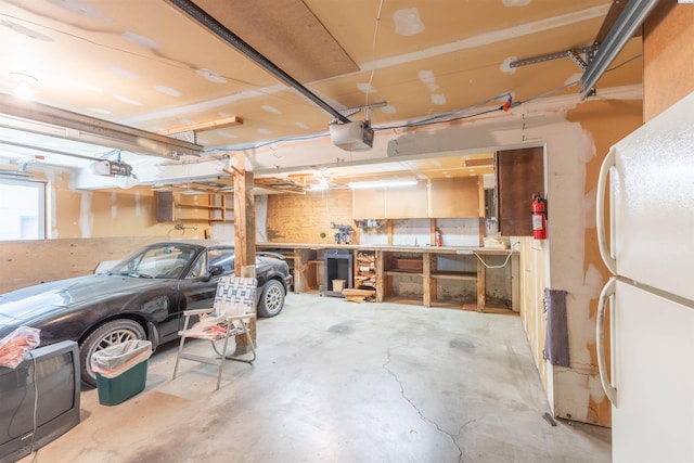 1835 NW Deane St, Pullman, WA 99163 - garage featuring freestanding refrigerator and a garage door opener