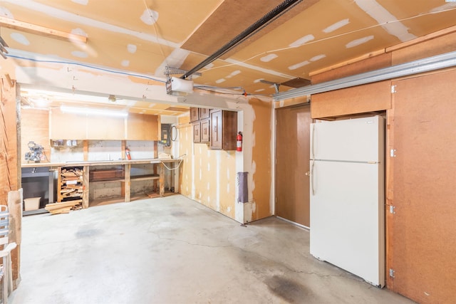 1835 NW Deane St, Pullman, WA 99163 - basement featuring freestanding refrigerator, a garage, and a workshop area