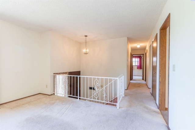 1835 NW Deane St, Pullman, WA 99163 - hall with carpet flooring, a chandelier, an upstairs landing, and a textured ceiling