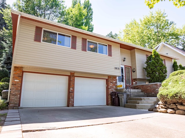1835 NW Deane St, Pullman, WA 99163 - split foyer home featuring a garage, driveway, and brick siding