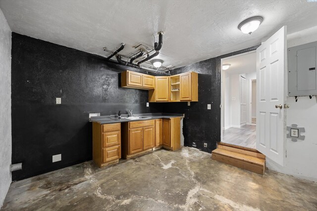 312 Mccabe St, Walla Walla, WA 99362 - kitchen featuring electric panel, a sink, unfinished concrete flooring, open shelves, and a textured ceiling