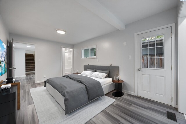 312 Mccabe St, Walla Walla, WA 99362 - bedroom with wood finished floors, baseboards, connected bathroom, and beamed ceiling