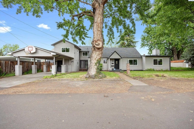 312 Mccabe St, Walla Walla, WA 99362 - view of front facade with concrete driveway, a carport, and a chimney