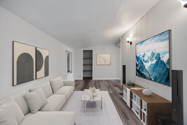 312 Mccabe St, Walla Walla, WA 99362 - living room with wood finished floors, built in shelves, a textured ceiling, and baseboards