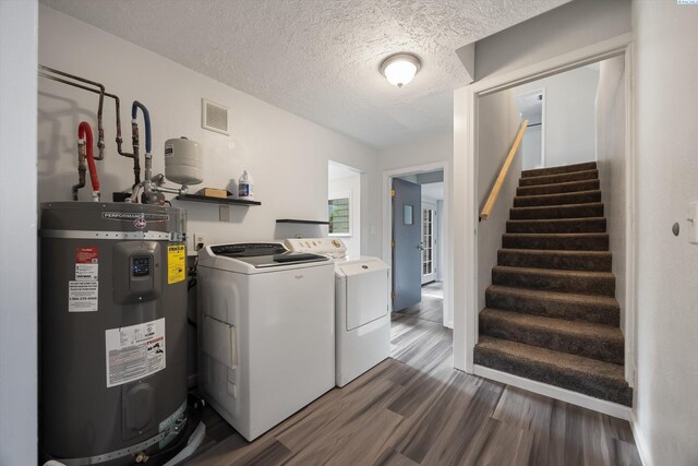 312 Mccabe St, Walla Walla, WA 99362 - laundry area with electric water heater, dark wood-type flooring, separate washer and dryer, and a textured ceiling