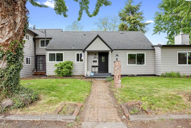312 Mccabe St, Walla Walla, WA 99362 - view of front of house featuring roof with shingles, a vegetable garden, and a front lawn