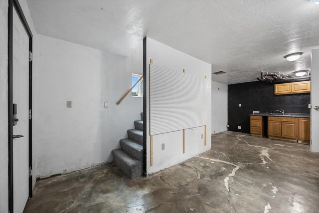 312 Mccabe St, Walla Walla, WA 99362 - unfurnished living room featuring concrete flooring and stairway