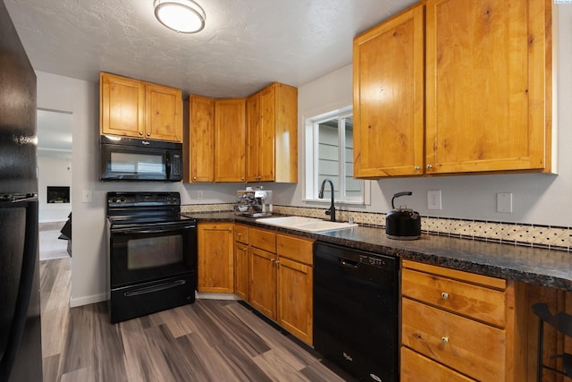 312 Mccabe St, Walla Walla, WA 99362 - kitchen with black appliances, a sink, dark wood-style flooring, and brown cabinets